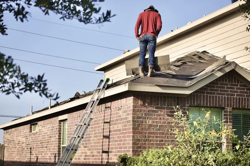 Professional roofer working on a residential roof in North Bridgeport
